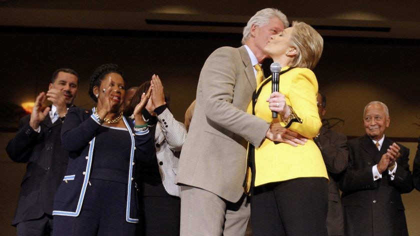 Bill Clinton embraces and kisses Hillary Clinton