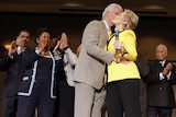 Bill Clinton embraces and kisses Hillary Clinton