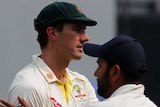 Pat Cummins congrtulates Rohit Sharma after second-test defeat.