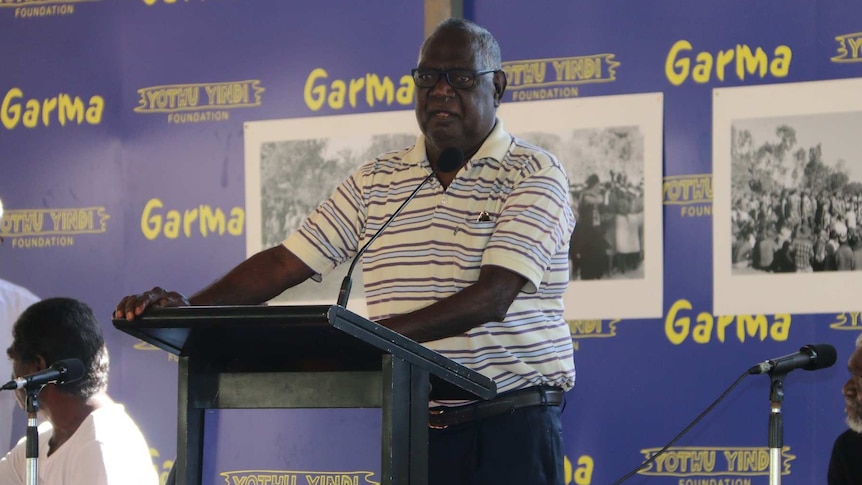 Galarrwuy Yunupingu speaks at a podium at the 2016 Garma Festival.