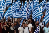 Golden Dawn supporters wave Greek national flags and shout slogans outside police headquarters in Athens.