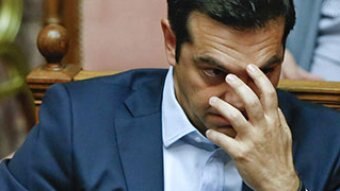 Tsipras holding head