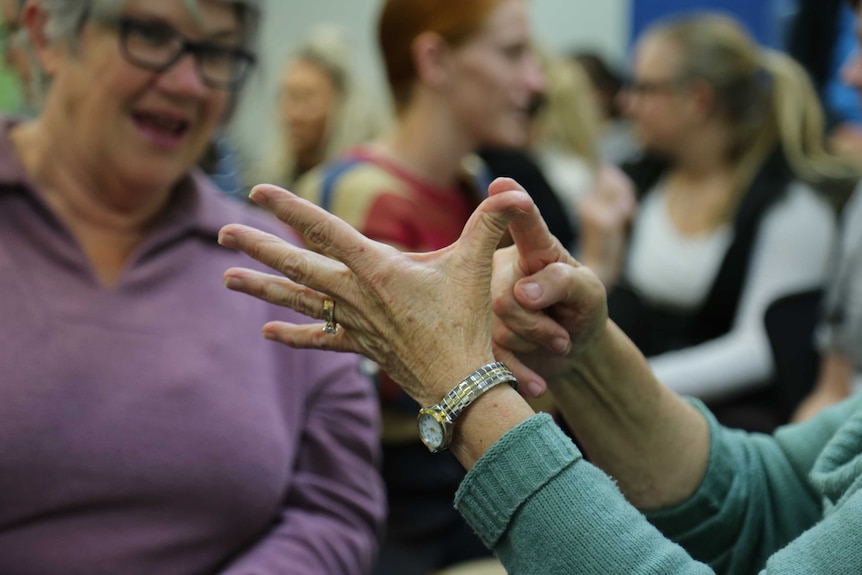 A close up image of a hand using sign language