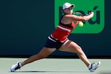 Ash Barty reaches for a backhand against Eugenie Bouchard at the Miami Open.