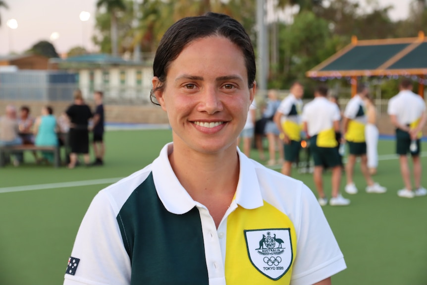Brooke Peris wears a green and gold polo and looks straight at the camera.
