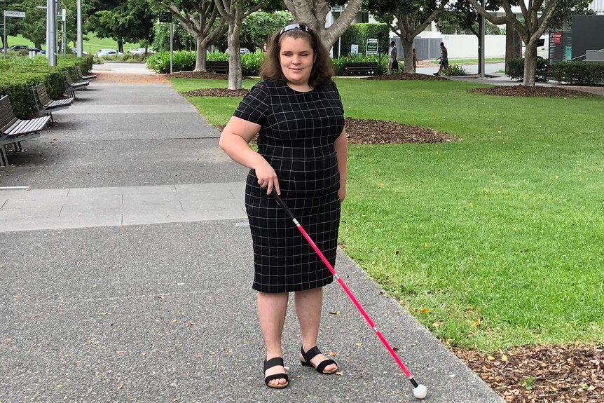 Brisbane woman Hailey Lindemann, who is blind, standing on a pathway.
