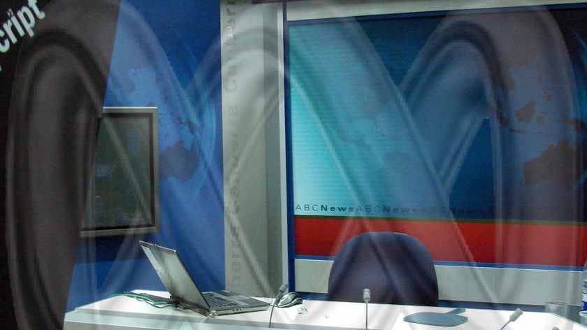 Emptry ABC TV news studio with ABC logo/'worm' superimposed/ghosted onto it
