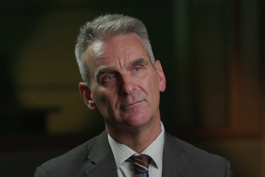 HEad shot of Elio Celotto in front of blurred grey/brown background