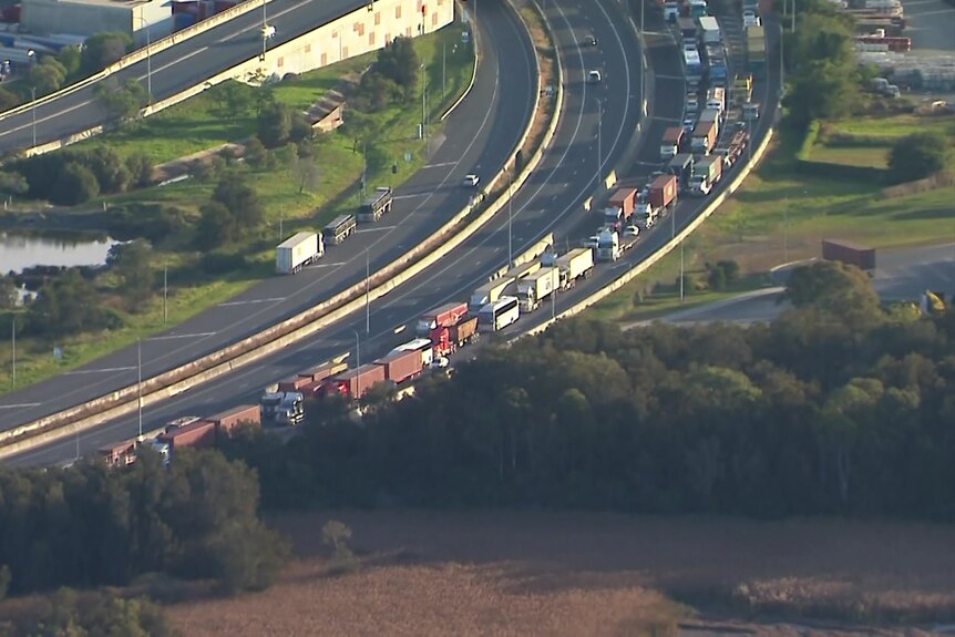 Vehicles bank up along a Brisbane road