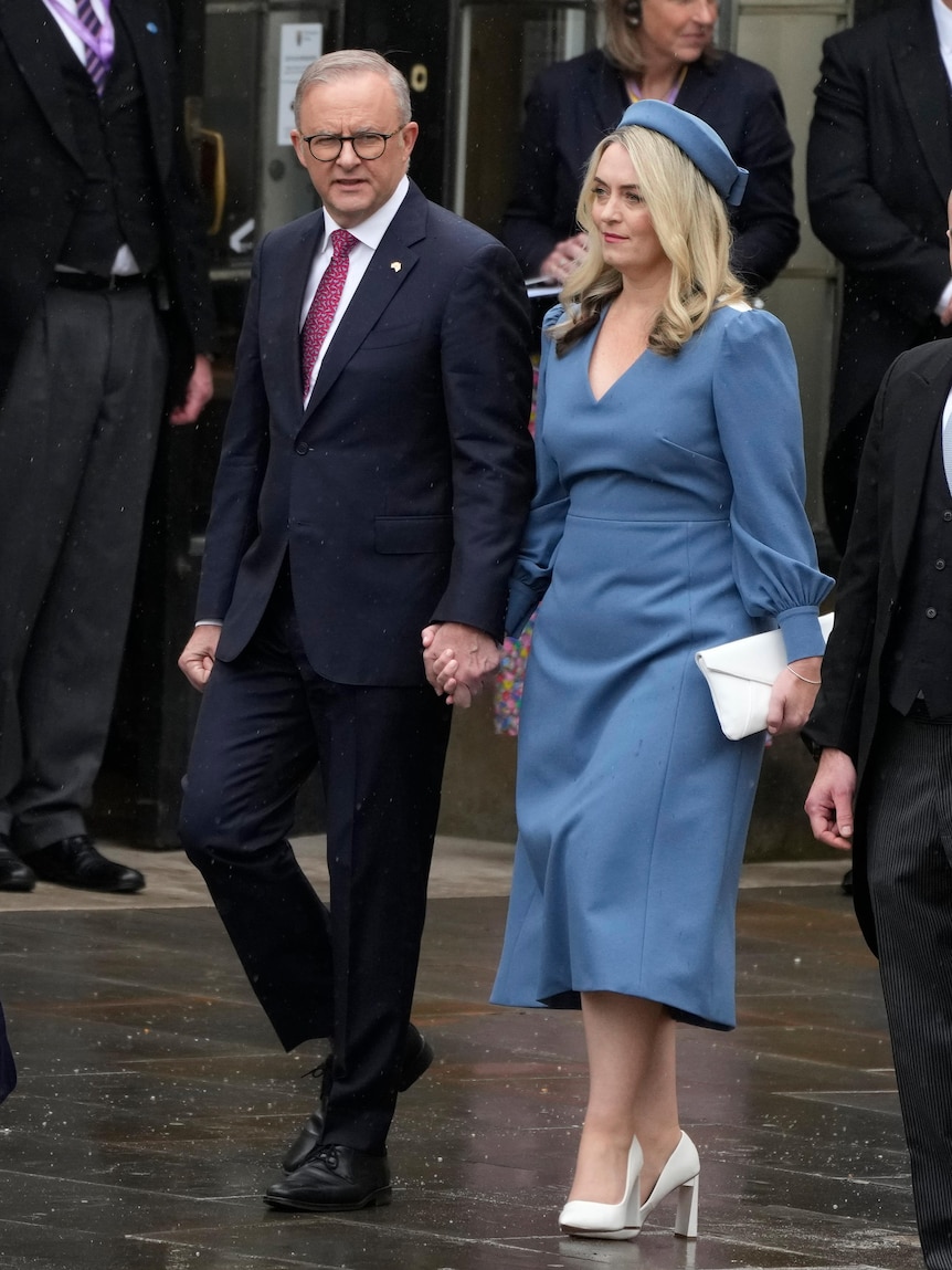 A woman and a man walking hand in hand