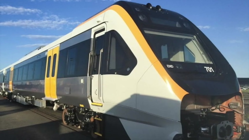 A close up of a new white and yellow train.