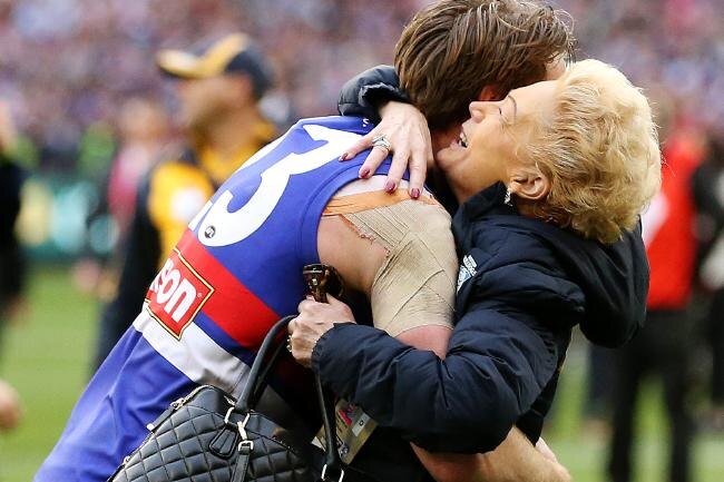 Susan Alberti hugs a Western Bulldogs footballer after the 2016 grand final.