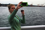 Picture of a woman drinking wine and taking a selfie in Seattle.