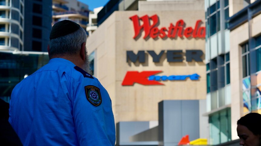 A NSW police chaplain and rabbi stands near the Westfield Bondi Junction shopping centre