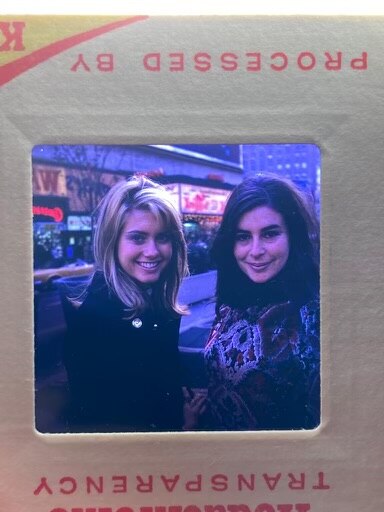 An old photo of two smiling young women.