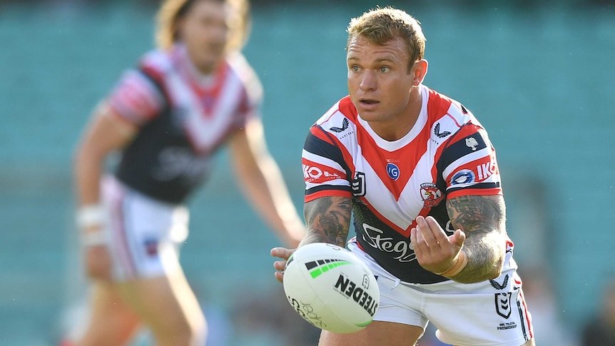 Jake Friend passes a rugby league ball with both hands