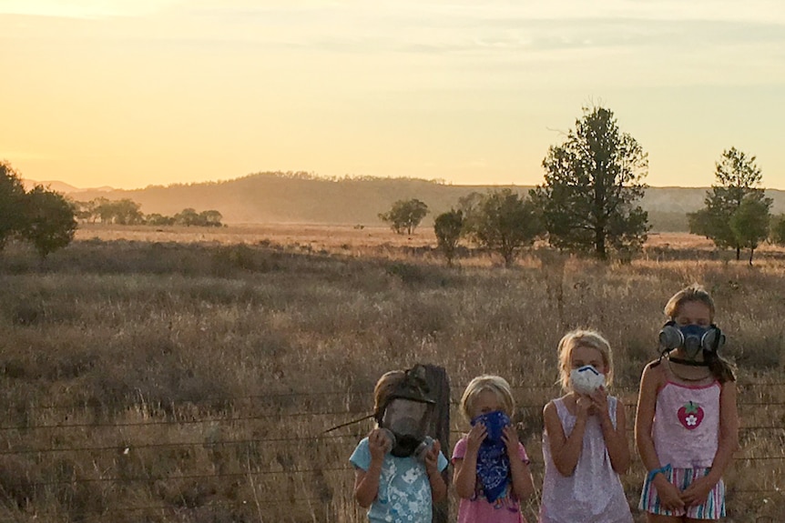 Pat Murphy's four daughters wear masks as they stand on their property on the Liverpool Plains in New South Wales.