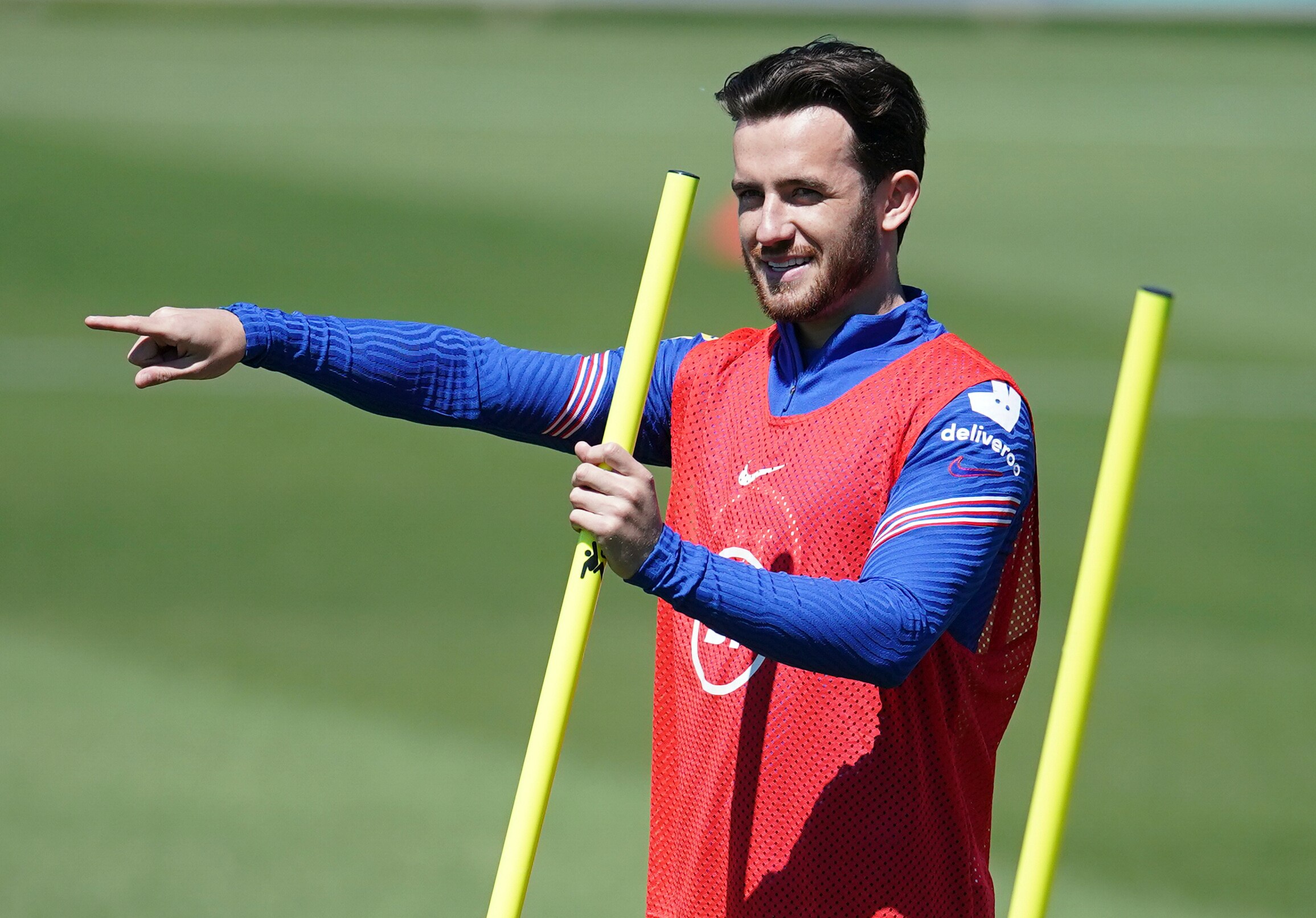 Ben Chilwell points while holding a yellow training pole