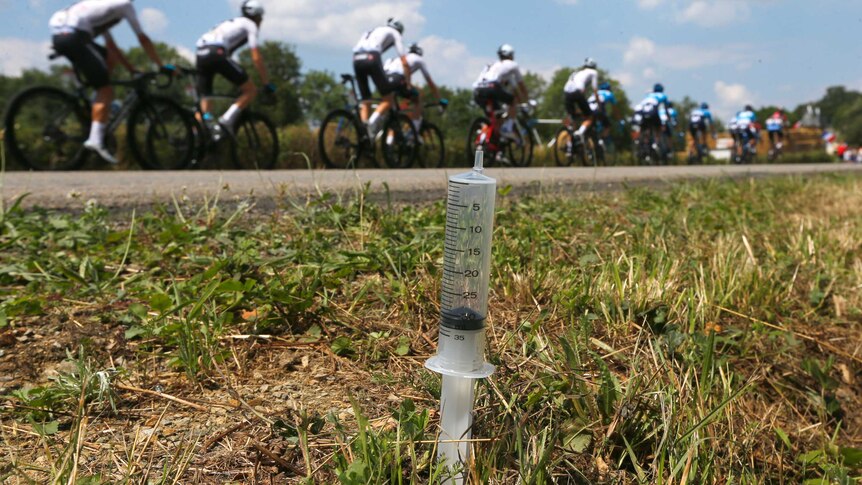 Team Sky rides by a syringe left on the side of the road during a stage of the Tour de France