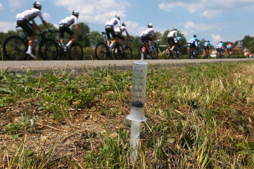 Team Sky rides by a syringe left on the side of the road during a stage of the Tour de France