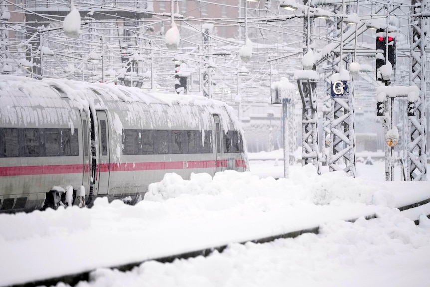 A train and its lines are covered in snow 