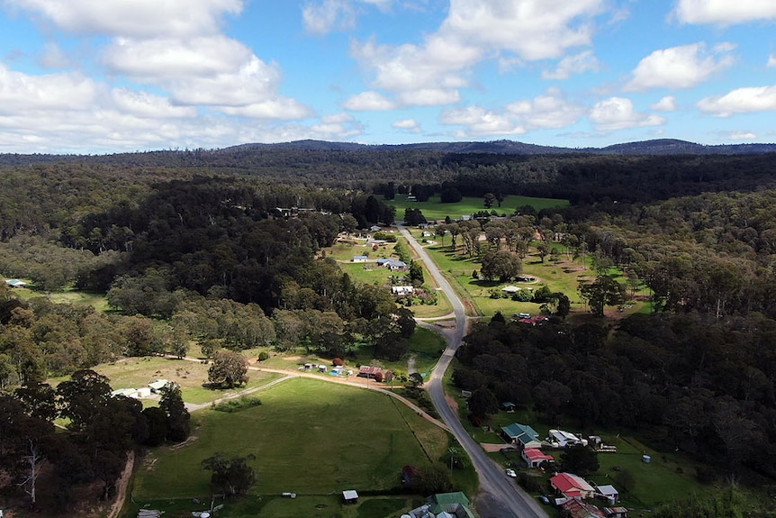 Aerial image of Benoc's main street, showing buildings closely flanked by expansive bushland