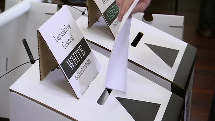 A ballot is placed in a ballot box marked Legislative Council