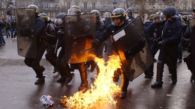 Police charge protesters in Paris at a rally against the new youth job laws.