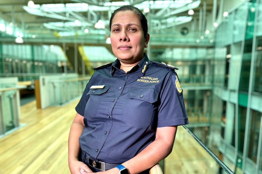 Woman wearing Australian Border Force uniform looking at the camera with a serious expression