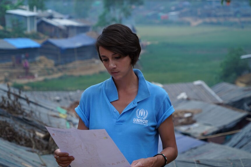 UNHCR planner Phoebe Goodwin looks at a document