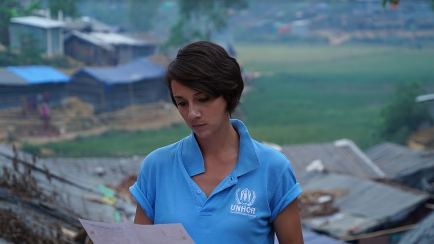 UNHCR planner Phoebe Goodwin looks at a document