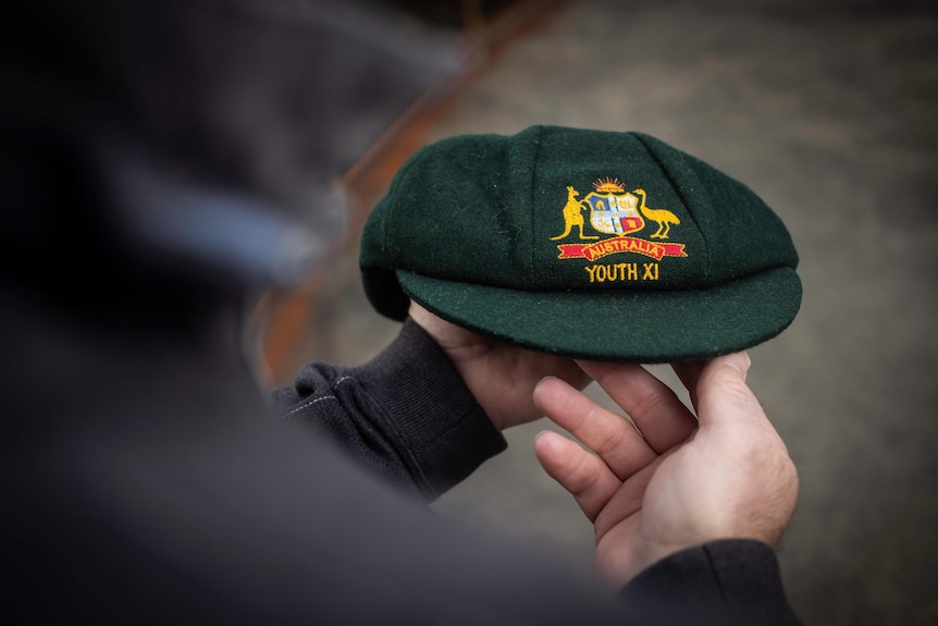 A picture of a green cap being held out in front of the camera.