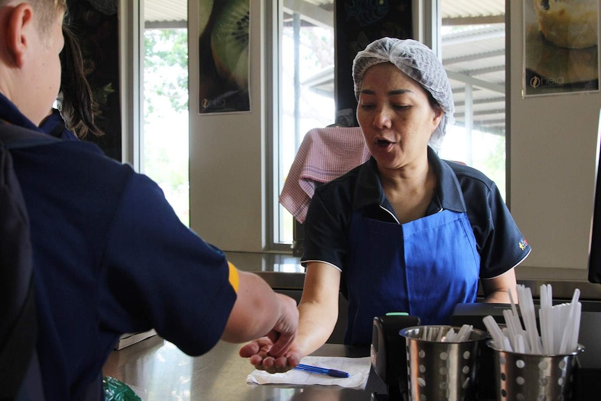 a cafe worker serves customers