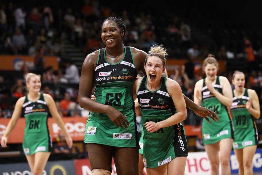 Jhaniele Fowler and Ingrid Colyer of the Fever celebrate after a win agianst the Giants in August.