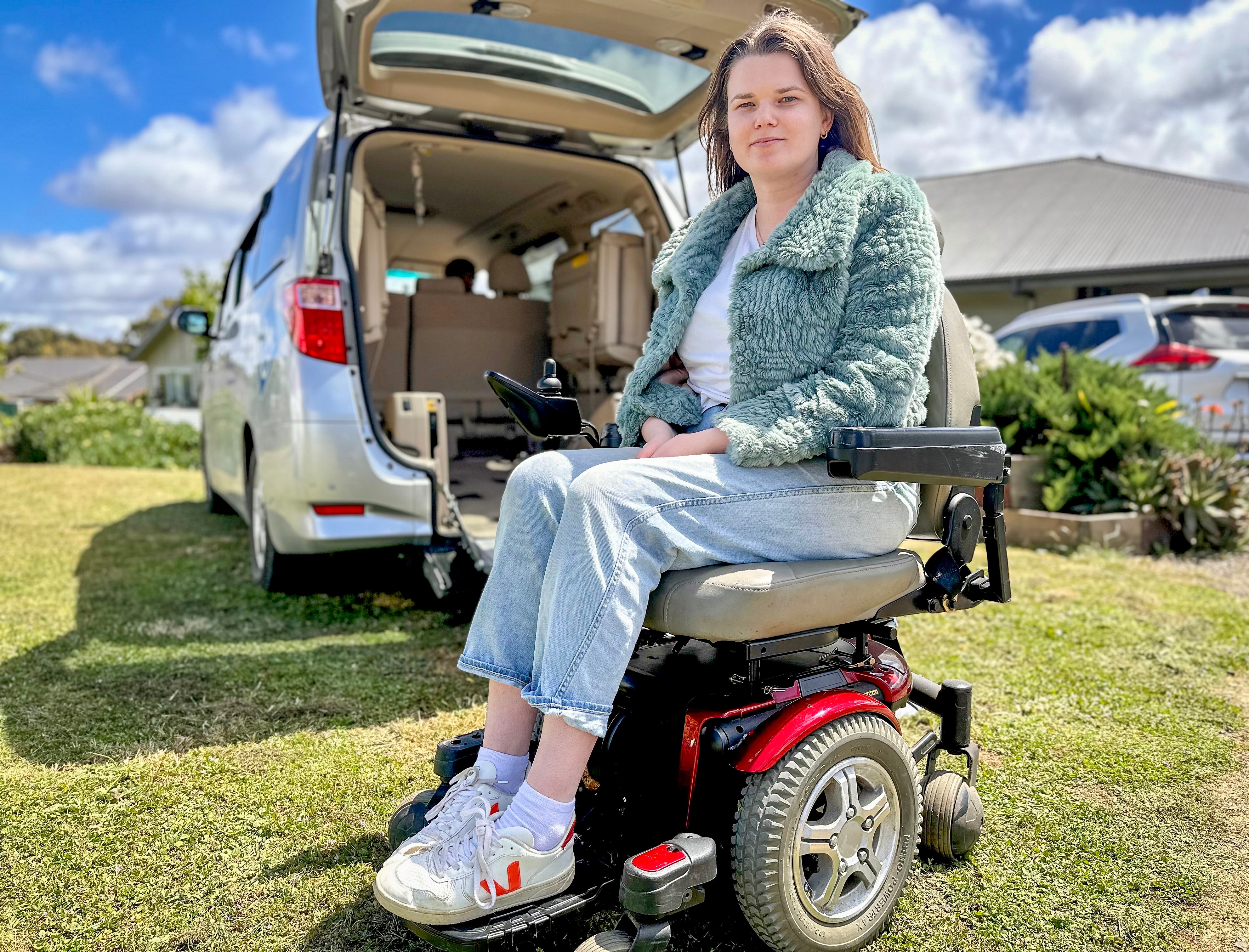 Maddy Zarb sitting in a wheelchair looking at the camera