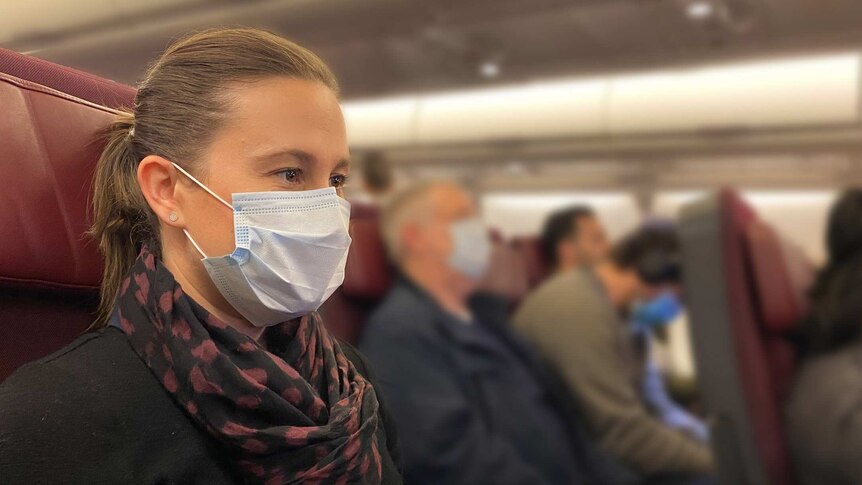 Photo of ABC News reporter Rachel Pupazzoni on a flight wearing a mask.