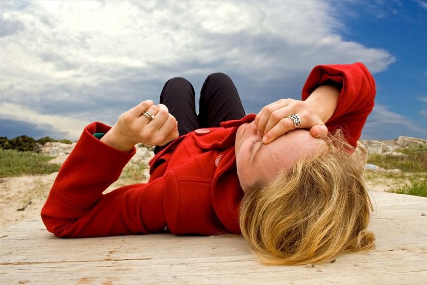 A woman lying on the ground after fainting