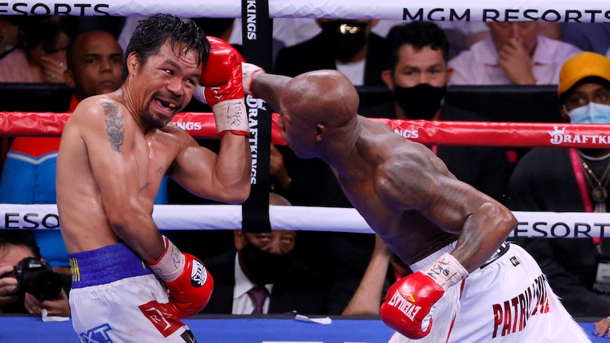 Manny Pacquiao shields a punch aimed towards his head