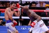 Manny Pacquiao shields a punch aimed towards his head