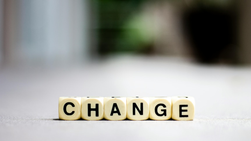 Photo of board game pieces spelling out the word Change