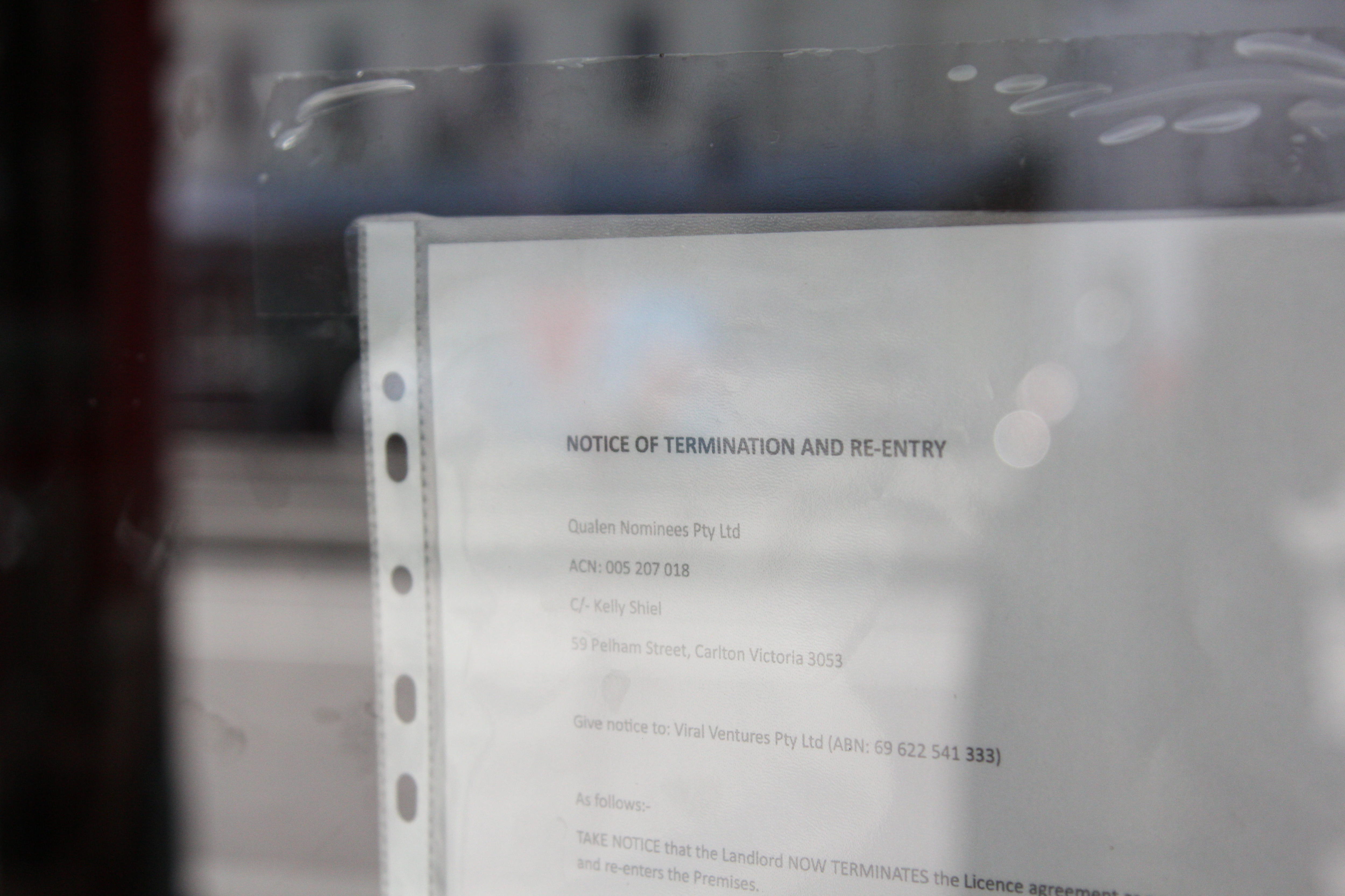 A close up of a piece of paper in a plastic sleeve from the a real estate agent calling for possession