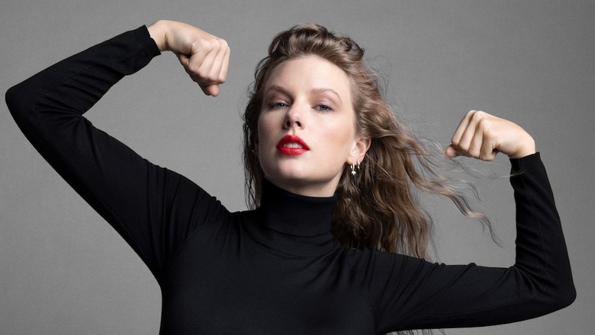 Taylor Swift, dressed in a black long-sleeved turtleneck and red lipstick, flexes her muscles in a photoshoot for Time.