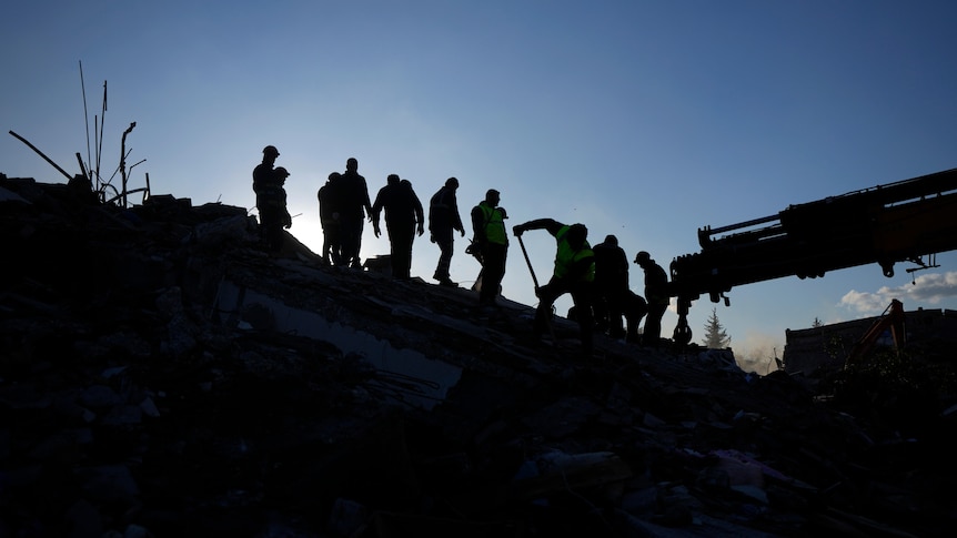 Rescue teams search for people in the rubble of destroyed buildings in Antakya.