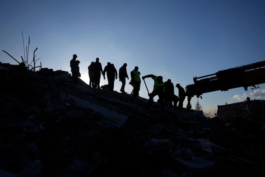 Rescue teams search for people in the rubble of destroyed buildings in Antakya.