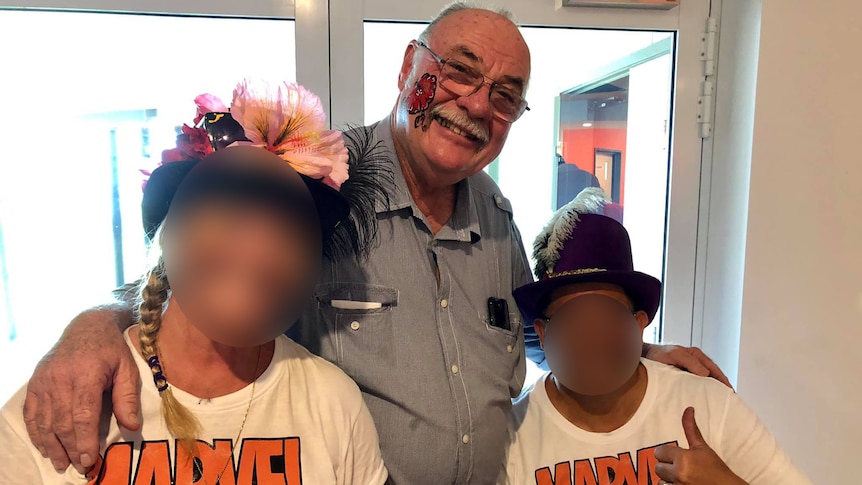 Warren Entsch with a flower painted on his face with two people in marvel t-shirt