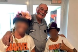 Warren Entsch with a flower painted on his face with two people in marvel t-shirt