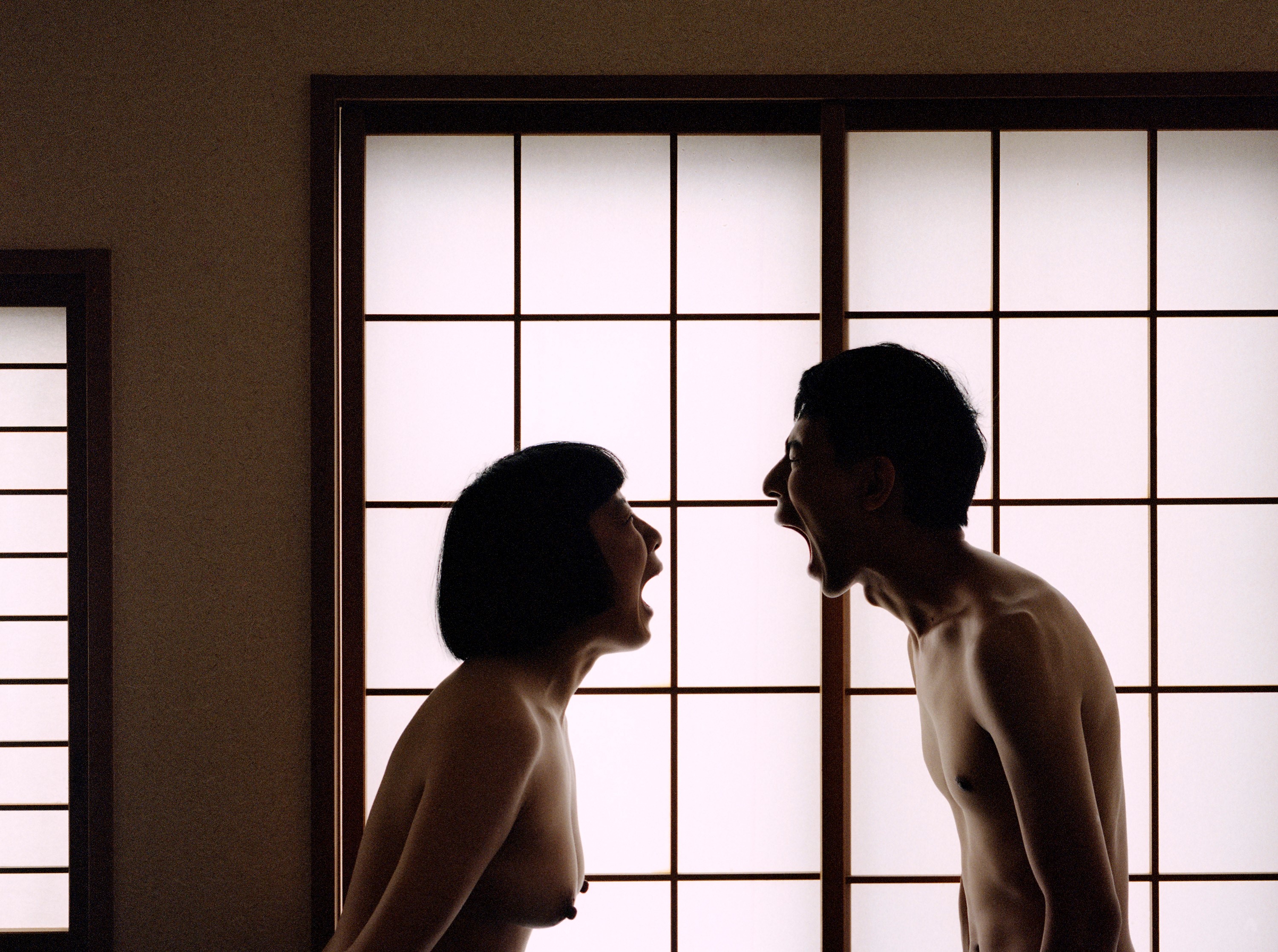 Pixy and Moro are facing each other, naked and screaming, silhouetted by a shoji.