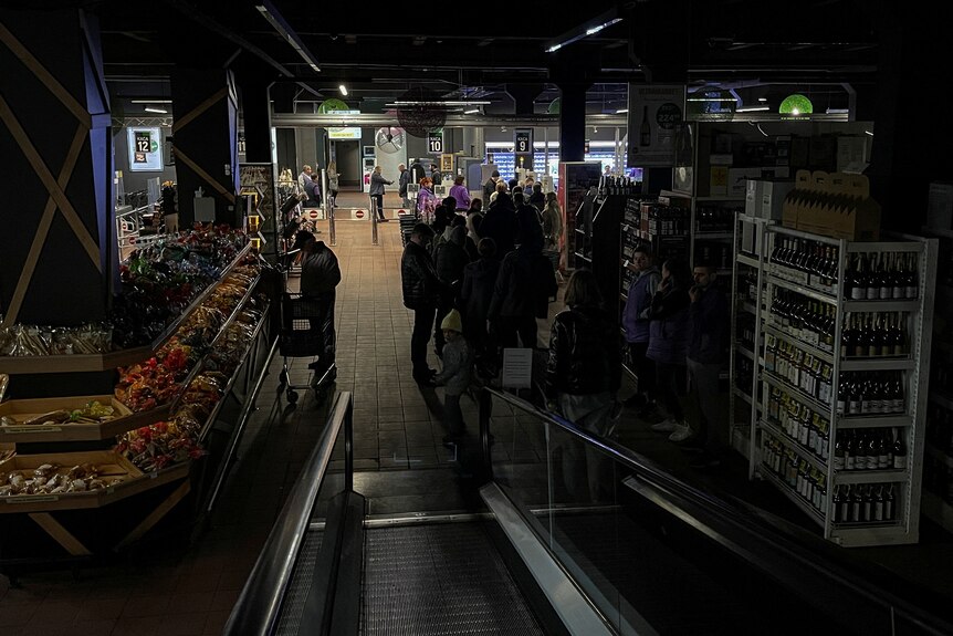 People inside a supermarket without electricity in Kyiv.