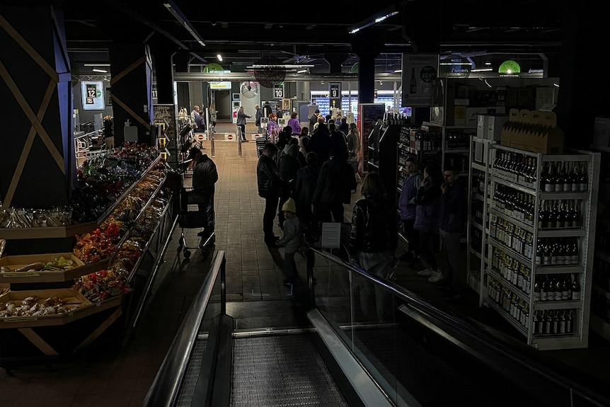 People inside a supermarket without electricity in Kyiv.