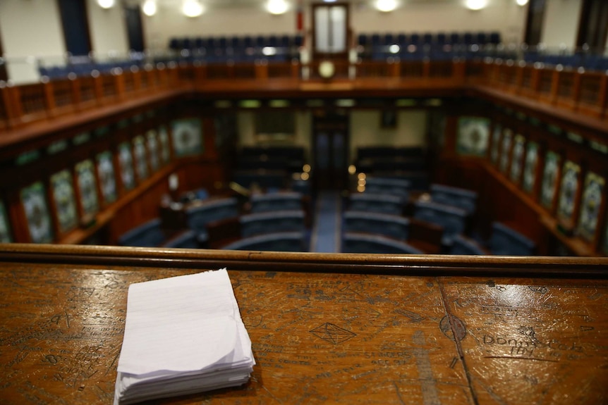 A notepad sits on the WA Parliament press gallery bench.